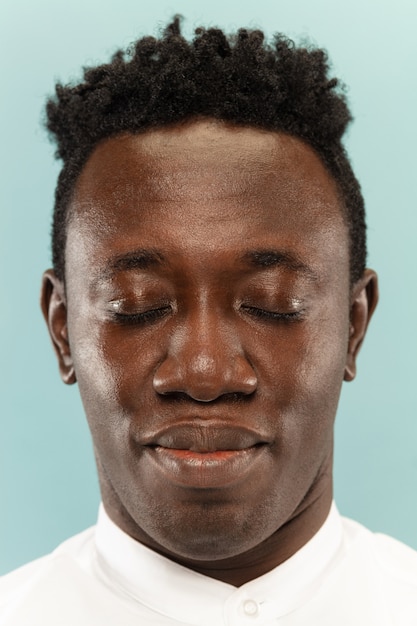 Close-up Portrait of a Young Man on a Blue Wall – Free Download