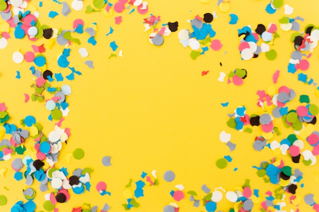 Confetti on Yellow Background After a Party – Free Download