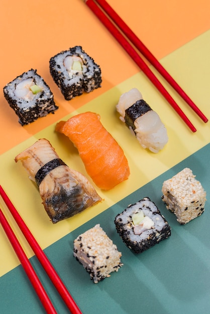 Chopsticks and Sushi Rolls on Table – Free Download