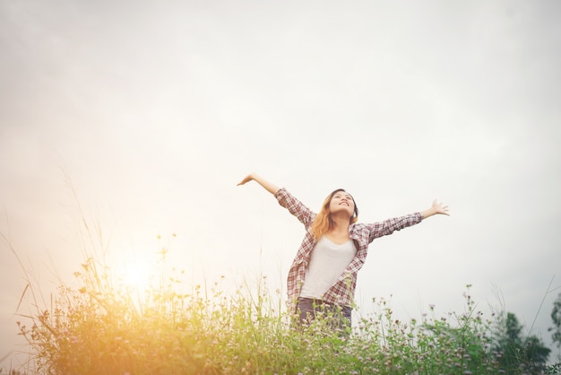 Young Beautiful Hipster Woman in a Flower Field at Sunset – Free to Download