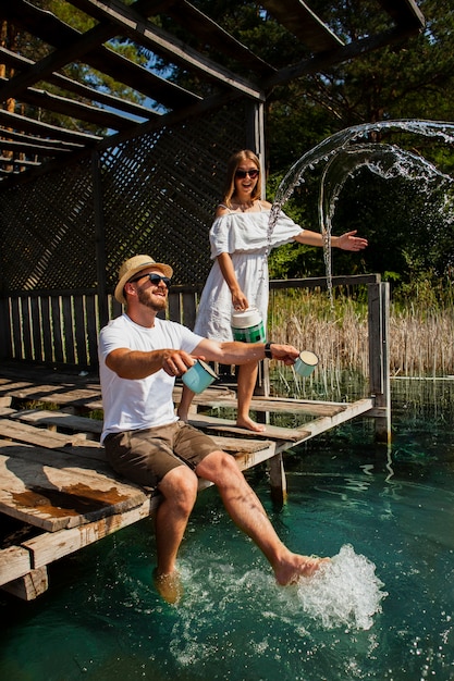 Couple Enjoying Leisure Time with Man Relaxing by the Water – Free Stock Photo, Download Free