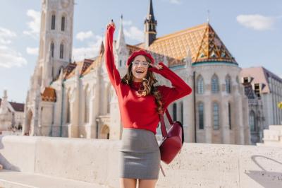 Excited Caucasian Girl in Glamorous Outfit Posing Emotionally Near a Beautiful Old Palace – Download Free Stock Photo