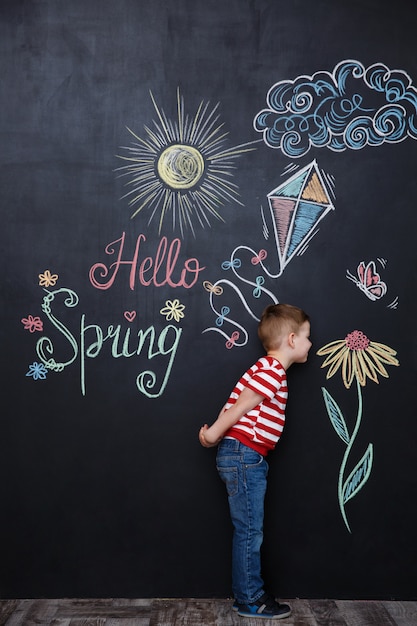 Little Cute Boy Smelling Flower on Chalkboard – Free Stock Photo for Download