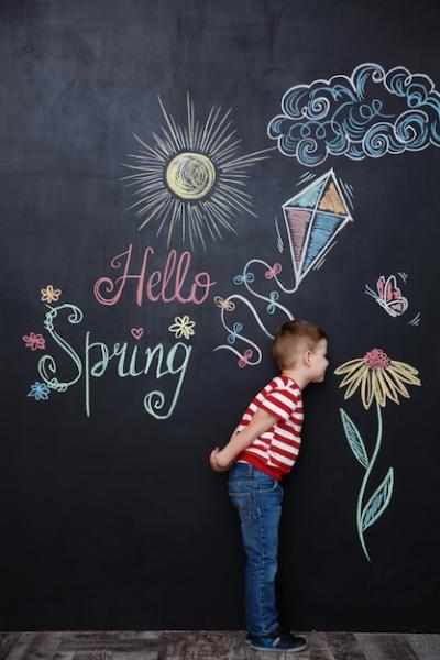 Little Cute Boy Smelling Flower on Chalkboard – Free Stock Photo for Download