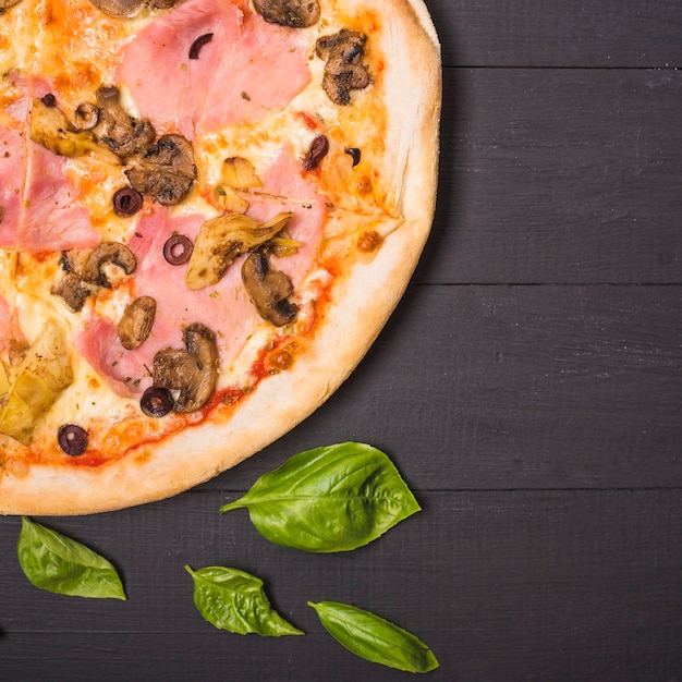 Mushroom and Meat Pizza with Basil Leaves on Wooden Plank – Free Stock Photo for Download