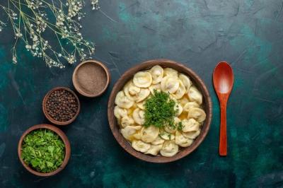 Delicious Dumpling Soup with Seasonings and Greens on Dark Background – Free Download