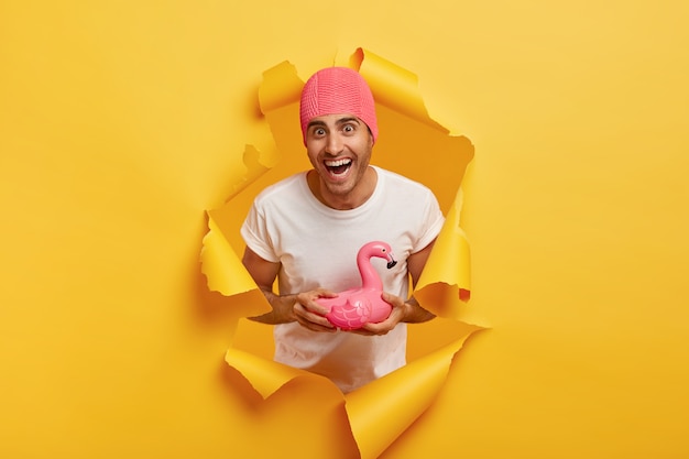 Happy Young Man in Pink Swim Cap with Flamingo Ring – Free Download