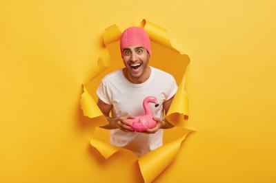 Happy Young Man in Pink Swim Cap with Flamingo Ring – Free Download