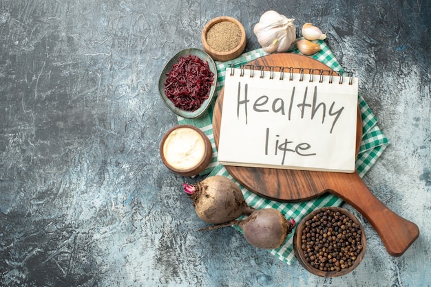 Healthy Lifestyle Notepad with Spices and Garlic on Grey Table – Free Stock Photo for Download