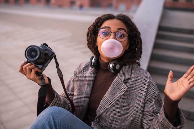 Woman Holding Camera and Blowing Bubbles – Free Stock Photo for Download