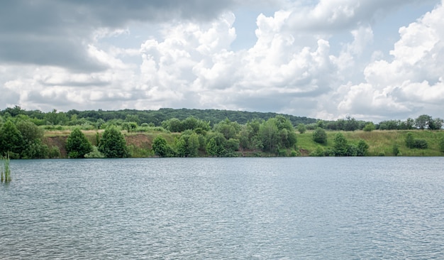 Summer Countryside Landscape with River, Forest, and Clouds – Free Download