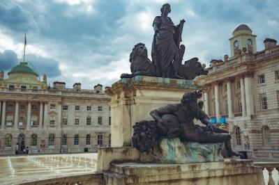 A Statue of a Woman with a Lion – Free Download Stock Photo