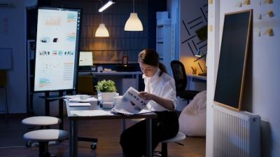 Businesswoman Analyzing Marketing Statistics in Company Office at Night – Free Download