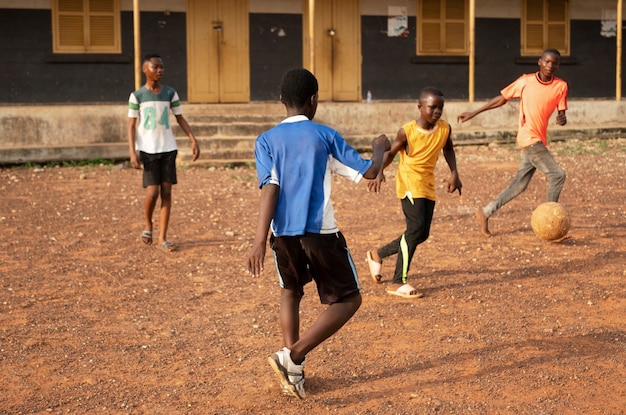 Kids Playing Football Outdoors – Free Download