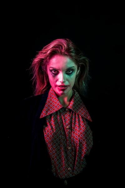 Medium Shot of a Woman Dressed as a Joker – Free Download