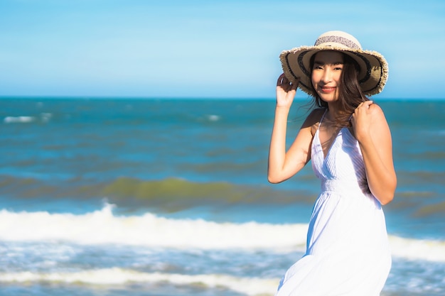 Beautiful Young Asian Woman Smiling and Relaxing by the Beach and Sea – Free Download