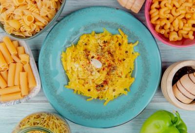 Macaroni Pasta on a Plate Surrounded by Raw Pasta – Free Download