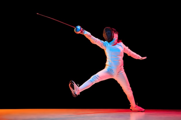 Teen Girl in Fencing Costume with Sword Isolated on Black Background – Free Stock Photo Download