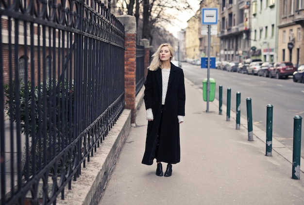 Young Woman in a Black Coat on the Street – Free Download