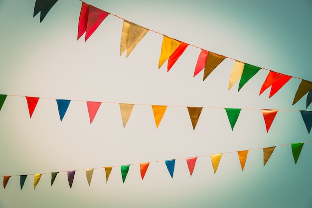 Colorful Flag Against a Clear Blue Sky – Free Stock Photo for Download