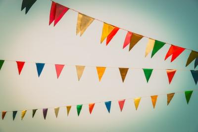 Colorful Flag Against a Clear Blue Sky – Free Stock Photo for Download