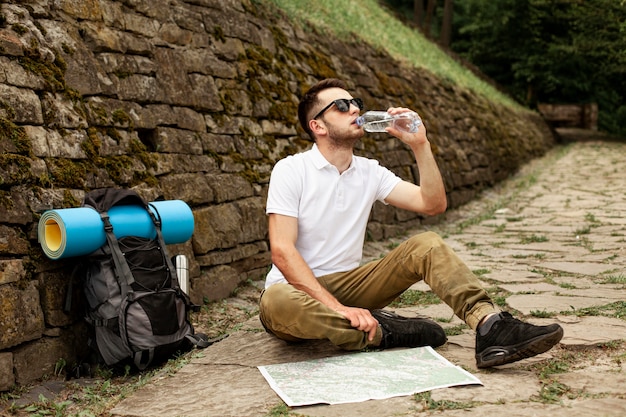 Traveler Consulting Map with Refreshing Hydration – Free Stock Photo Download