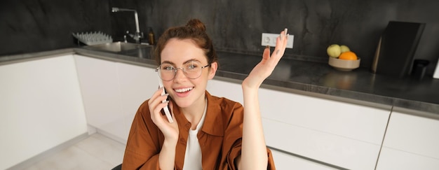 Beautiful Modern Woman Working from Home with Laptop in Kitchen – Free Stock Photo for Download