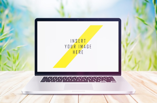 Laptop Mockup on Wooden Floor with Plant Background – Free Download