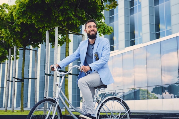 Luxury Bearded Male in Sunglasses Riding a Bicycle Downtown – Free Download