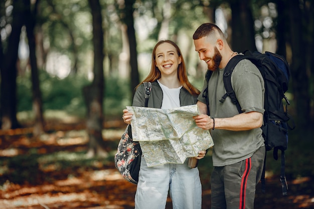 Cute Couple Enjoying a Rest in a Serene Forest – Free Download