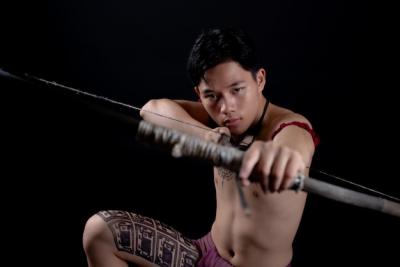 Young Male Warrior from Thailand Posing with a Bow – Free Download