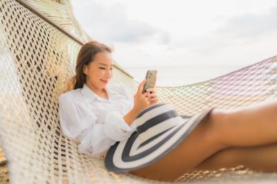Beautiful Young Asian Woman Relaxing on Beach Hammock – Free Download