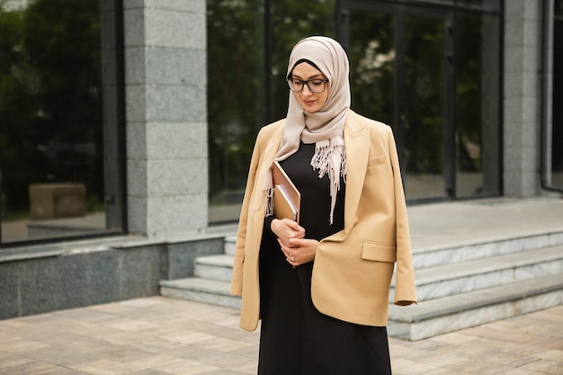 Muslim Woman in Hijab and Abaya with Laptop on City Street – Free Stock Photo, Download Free