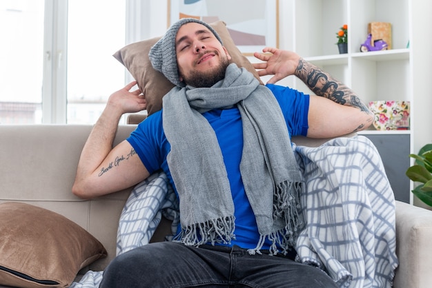 Pleased Young Man in Winter Fashion Relaxing on Sofa – Free Stock Photo, Download Free