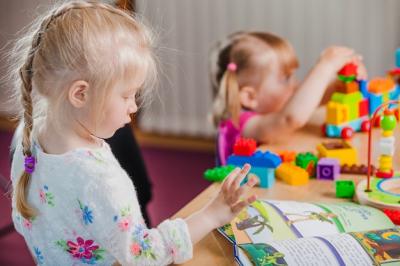 Girls Reading with Colorful Toys – Free Stock Photo for Download