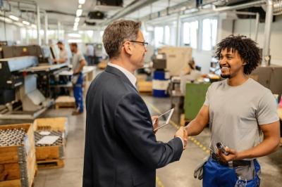 Happy Black Manual Worker Shaking Hands with Engineer at Factory Plant – Free Download