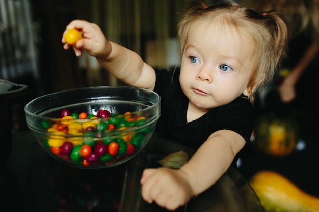 Little Girl Holding a Yellow Candy – Free Stock Photo for Download