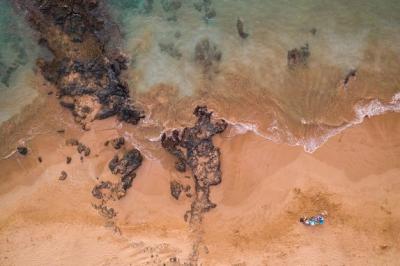 Aerial Shot of a Female Laying on the Beach Shore – Free to Download