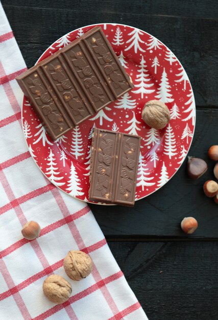 Milky Chocolate with Nuts on a Red Plate: Free Download