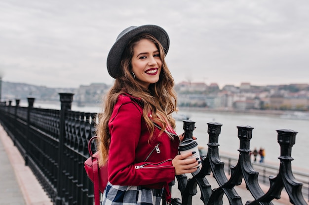 Pretty Curly Woman Enjoying Autumn City View with Bright Makeup – Free Stock Photo for Download