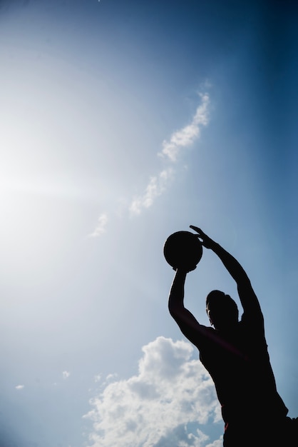 Silhouette of a Basketball Player Ready to Throw – Free Download