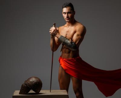 Muscular Man as an Ancient Roman Soldier with Sword in a Red Dress – Free Download