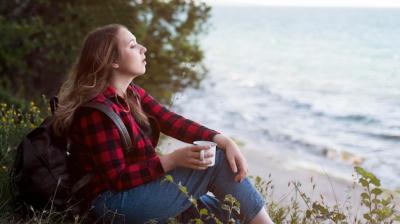 Brown Haired Woman Sitting on Ground Gazing at the Sea – Free Stock Photo Download