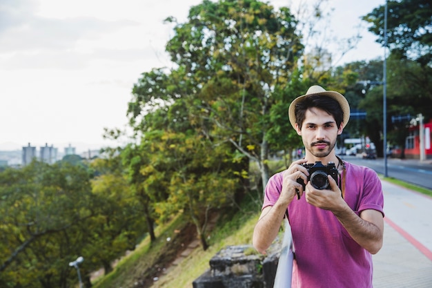 Guy with Camera on Sidewalk – Free Stock Photo for Download