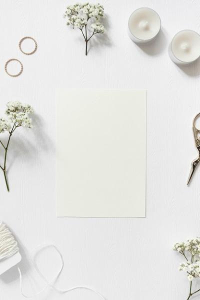 Blank Card Surrounded by Gypsophila and Wedding Rings on White Background – Free Download