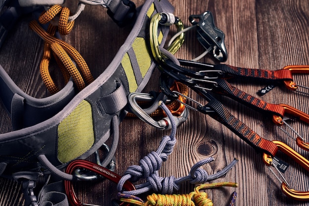 Colorful Climbing Carabiners and Knots on a Wooden Surface – Free Download