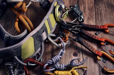 Colorful Climbing Carabiners and Knots on a Wooden Surface – Free Download