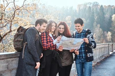 Young People Exploring an Autumn Forest with a Map – Free Stock Photo for Download