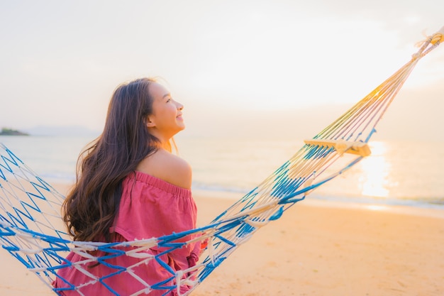 Beautiful Young Asian Woman Relaxing on a Hammock by the Beach – Free Download