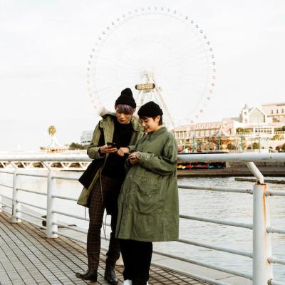 Couple Holding Devices Outdoors – Free Download